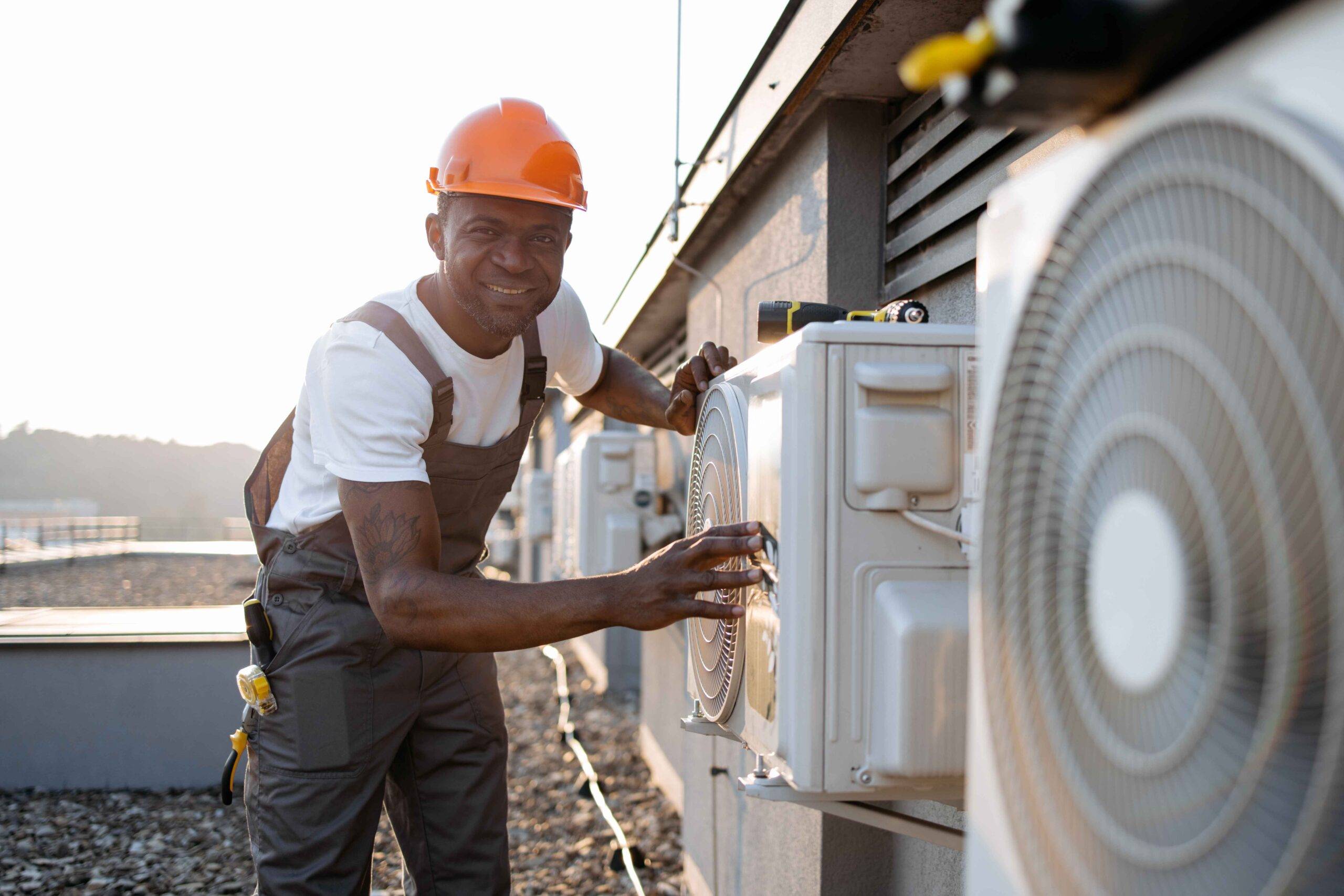 african-man-in-uniform-checking-air-conditioner-on-2023-12-21-22-00-43-utc_11zon